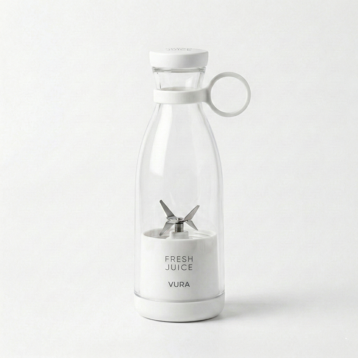 Clear blender with white base and lid on a white-grey background