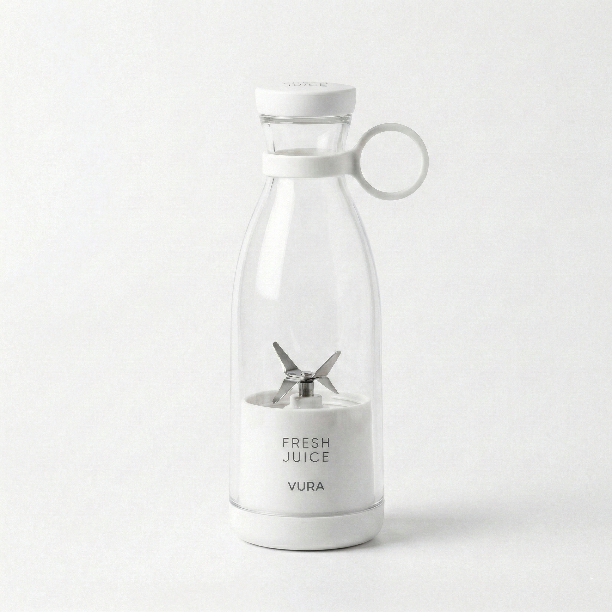 Clear blender with white base and lid on a white-grey background